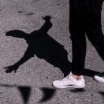 person wearing pair of white shoes