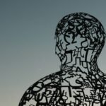 a sculpture of a man with letters all over it